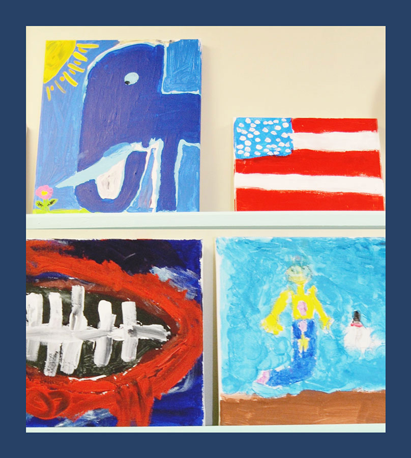 A collection of colorful paintings displayed on a wall.