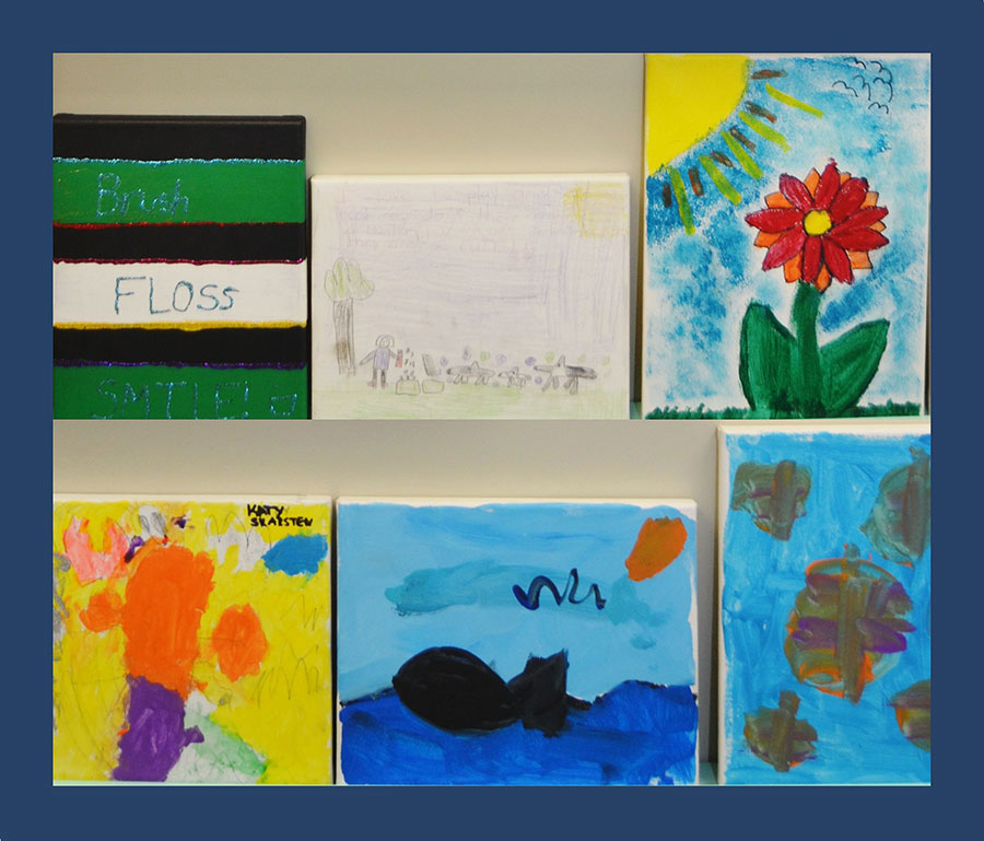 The image displays a collection of colorful artwork on display, featuring various illustrations and paintings with diverse subjects such as flowers, animals, and landscapes, presented in a grid format against a white background.