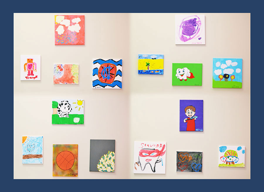 The image shows a collection of colorful paintings displayed on a wall, each with its own unique design and style.